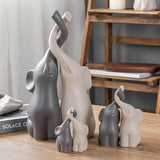 les trois tailles de Statuette Éléphant Trompe En l'Air sur une table